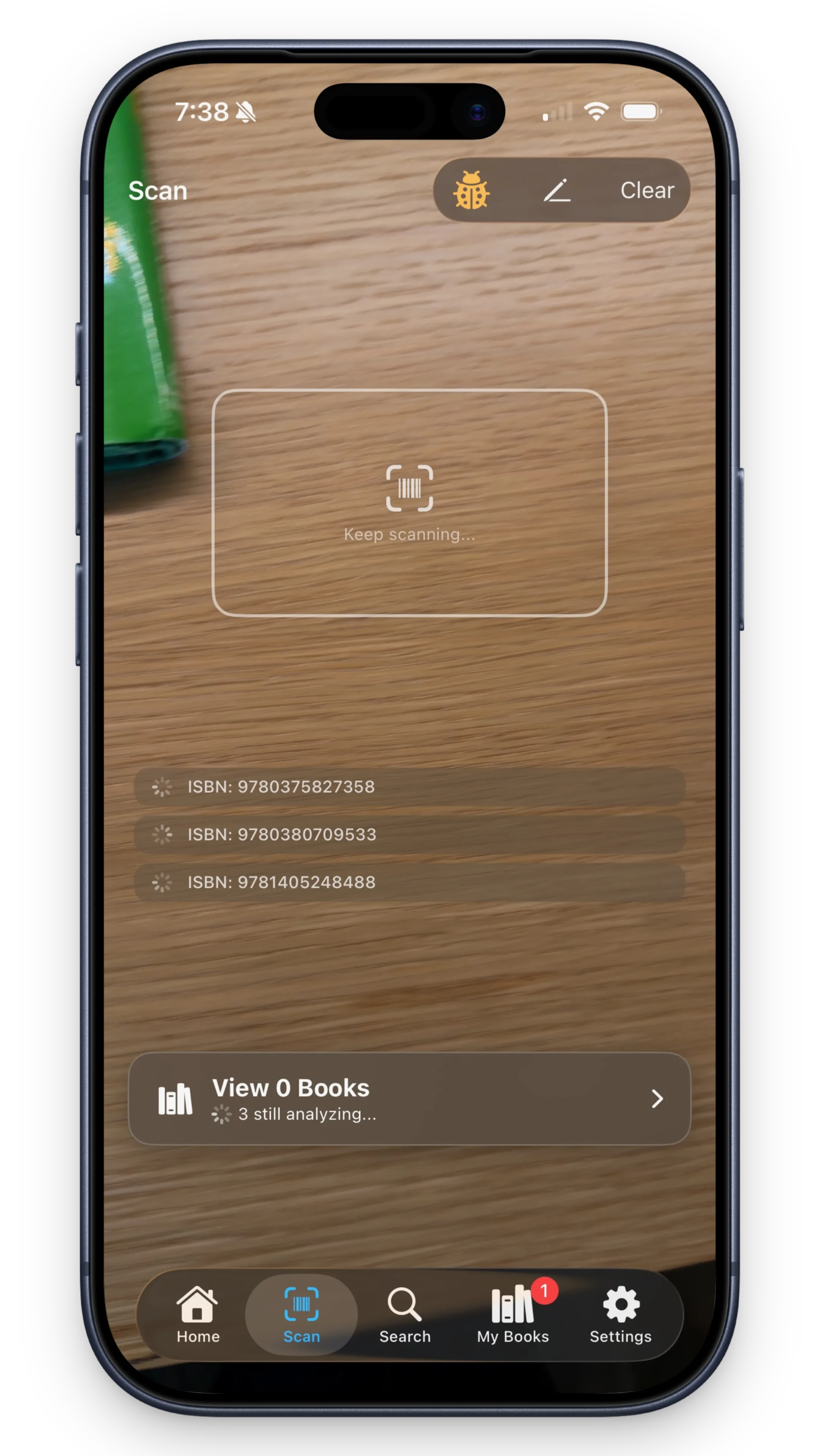 Batch scanning books with queue showing multiple ISBNs being analyzed